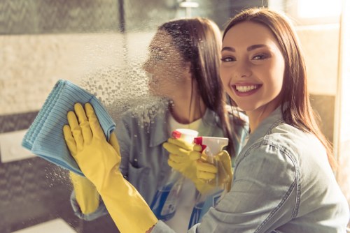 Gloved cleaner using professional equipment and protective measures
